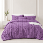 Purple tufted comforter set on a bed