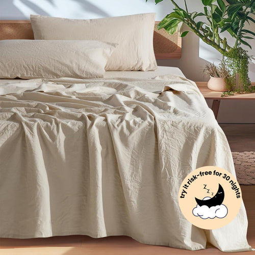 Beige European linen sheet set on an oak bed