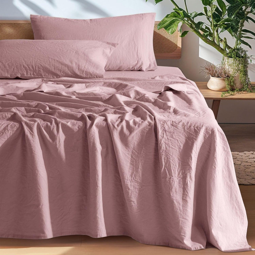 Pink European linen sheet set on an oak bed