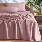 Pink European linen sheet set on an oak bed