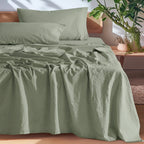 Green European linen sheet set on an oak bed
