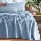 Blue European linen sheet set on an oak bed