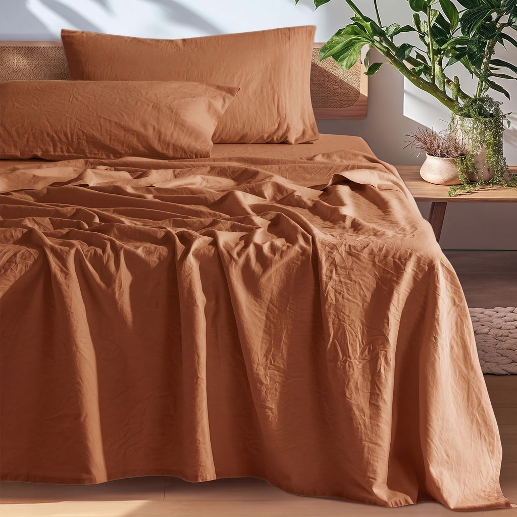 Rust European linen sheet set on an oak bed