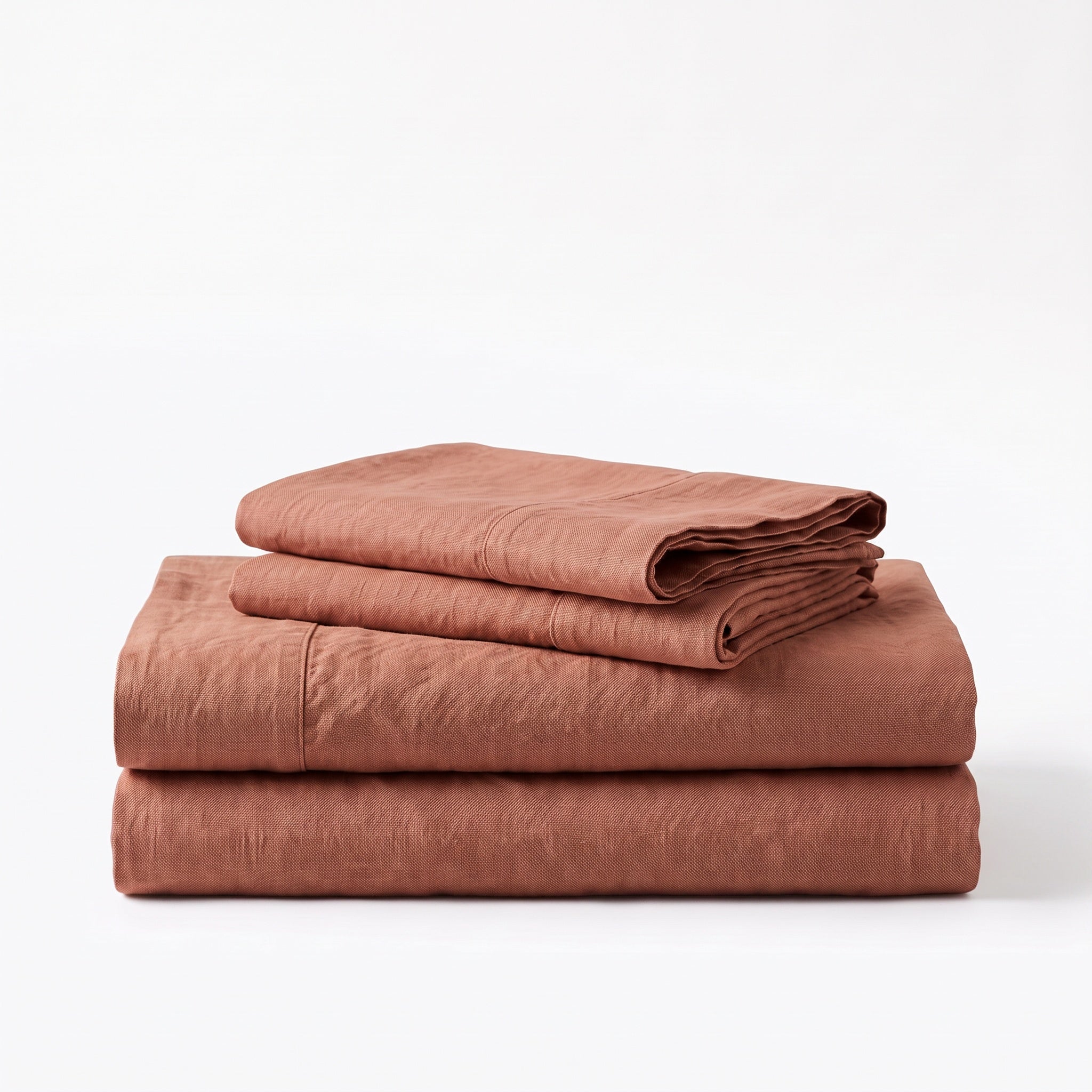 Folded stack of Rust European linen sheets