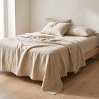 Beige European linen sheet set on an oak bed